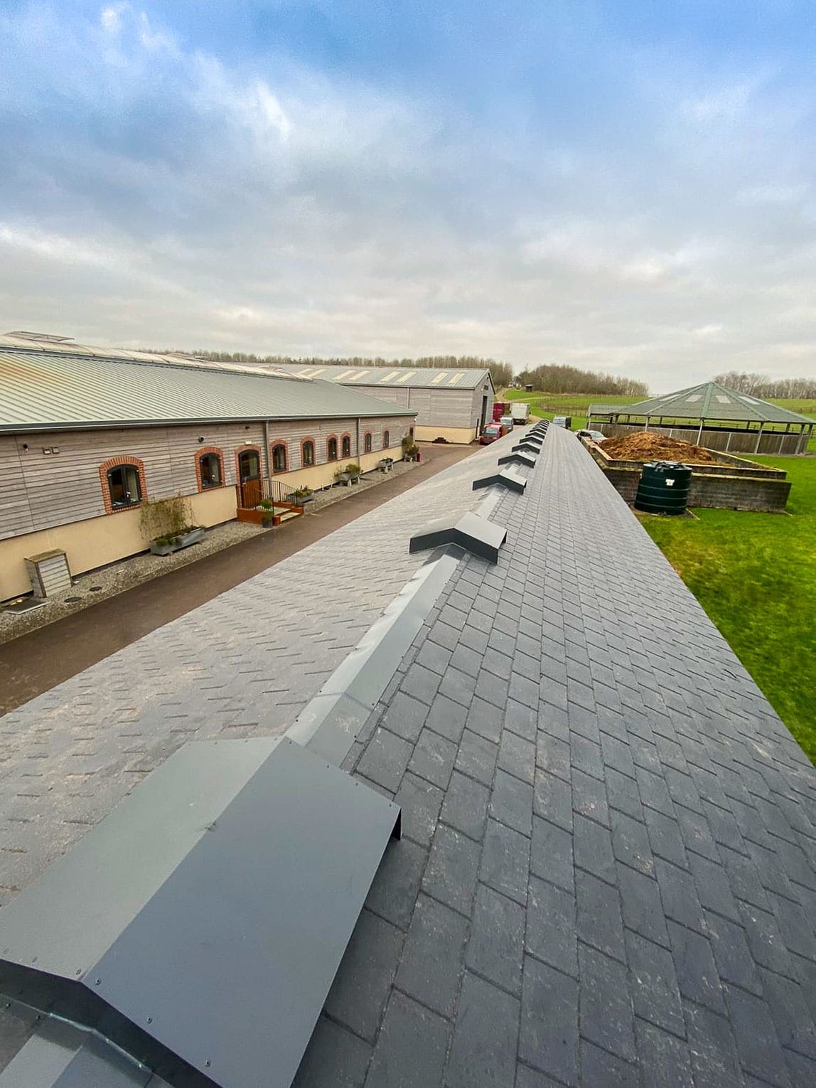 Detailed view of a synthetic slate roof on a Barn, showcasing its stylish appearance and lightweight design