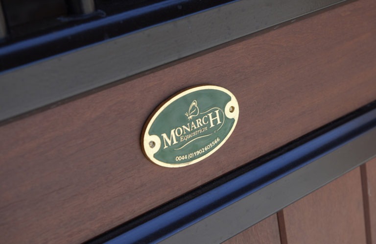 Monarch Equestrian Badge on Hardwood Stable Door Seeking Agents